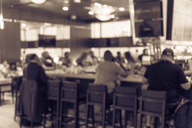 Vintage tone blurred group of people at airport bar. Abstract passengers dinning in, enjoy alcohol beverage and watching sport while waiting for flights clipart