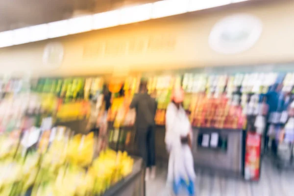 Blurred background image customer shopping at local grocery store in San Francisco, California. Fresh fruits and vegetables on display. Organic, locally grown produces, healthy food in supermarket