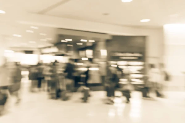 Vintage tone blurry motion people queuing in line at airport coffee shop in San Francisco airport, California, USA. Blurred customer waiting with luggage, baggage at terminal cafe restaurant