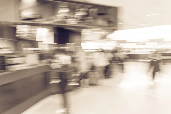 Vintage tone blurry motion people queuing in line at airport coffee shop in San Francisco airport, California, USA. Blurred customer waiting with luggage, baggage at terminal cafe restaurant