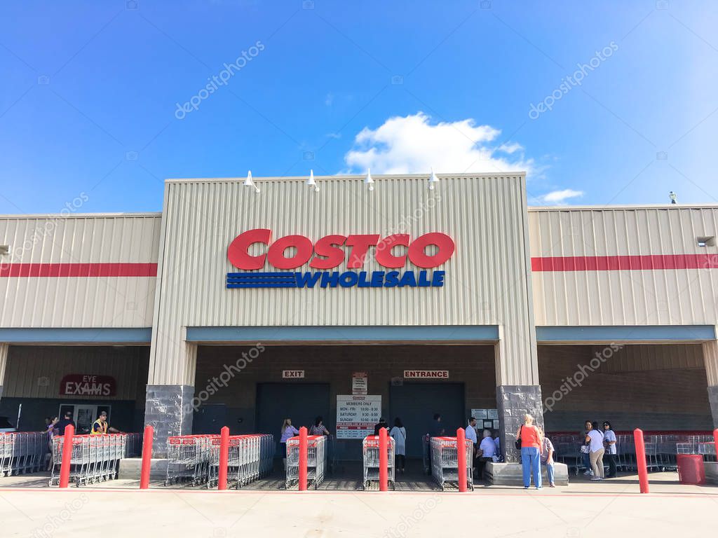 LEWISVILLE, TX, US-AUG 5, 2018:Close-up logo at facade exterior of Costco Wholesale store. Diverse group of customer waiting for opening hour in morning time, cloud blue sky