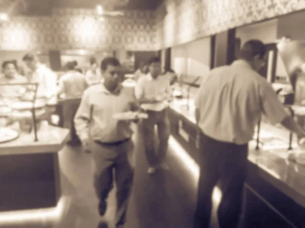 Vintage tone motion blurred Indian buffet restaurant in Irving, Texas, USA. People self serving flavored vegetarian and meat Indian dishes