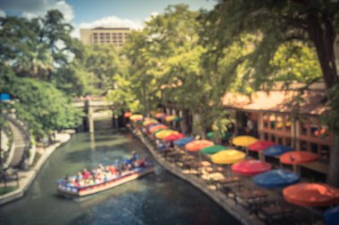 Vintage sesi bulanıklık renkli nehir yürümek şehir San Antonio, Texas, bize. Çok renkli şemsiye Cafe, Restoran. Turistler tekne turu, anlatı kılavuzu boyunca ünlü ve tarihi hedef binme keyfini çıkarın