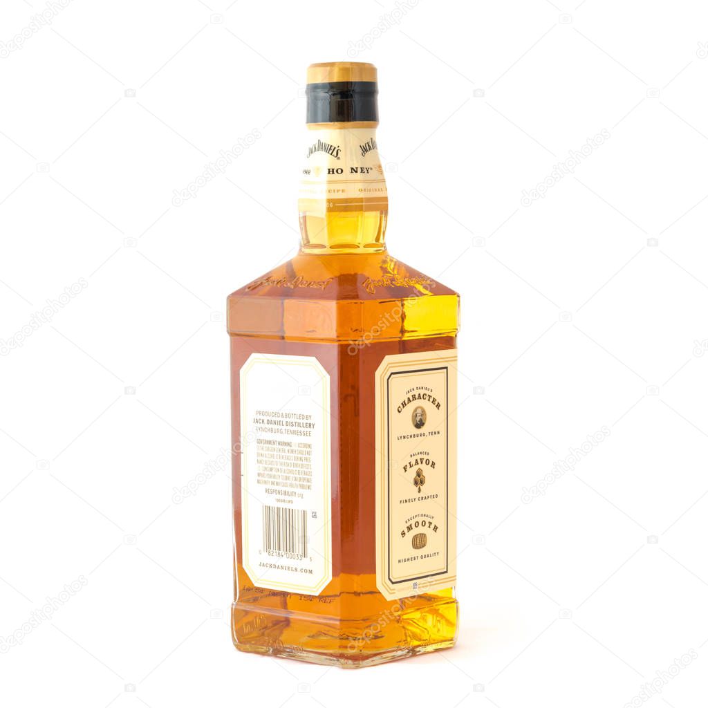 IRVING, TX, US-AUG 4, 2018:Side view studio shot bottle of Jack Daniels Tennessee Honey isolated on white. Blend whiskey and unique honey liqueur, vanilla, cinnamon, balanced naturally smooth drink