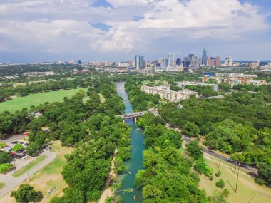 Aerial view Downtown from Barton Creek in Greenbelt at Zilker Metropolitan Park south Austin with summer blue cloud sky. Located at eastern edge of Hill Country, Austin the state capital of Texas, US. clipart