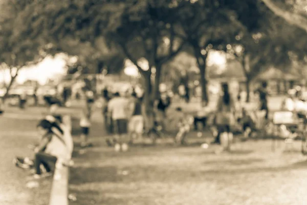 Vintage tone blurred image group of local Latino people enjoy BBQ at Bear Creek Park in Houston, Texas, US. BBQ grill in park with family and friends. Meat skewers smoke. Party and Picnic Concept