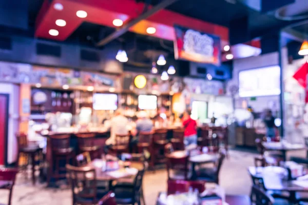 Blurred image sport and gumbo, oyster bar with TV, classic counter, tables and chairs in Houston, Texas, US. Bar Happy Hour, dine in abstract background. Night club, grill bar concept. Vintage filter.