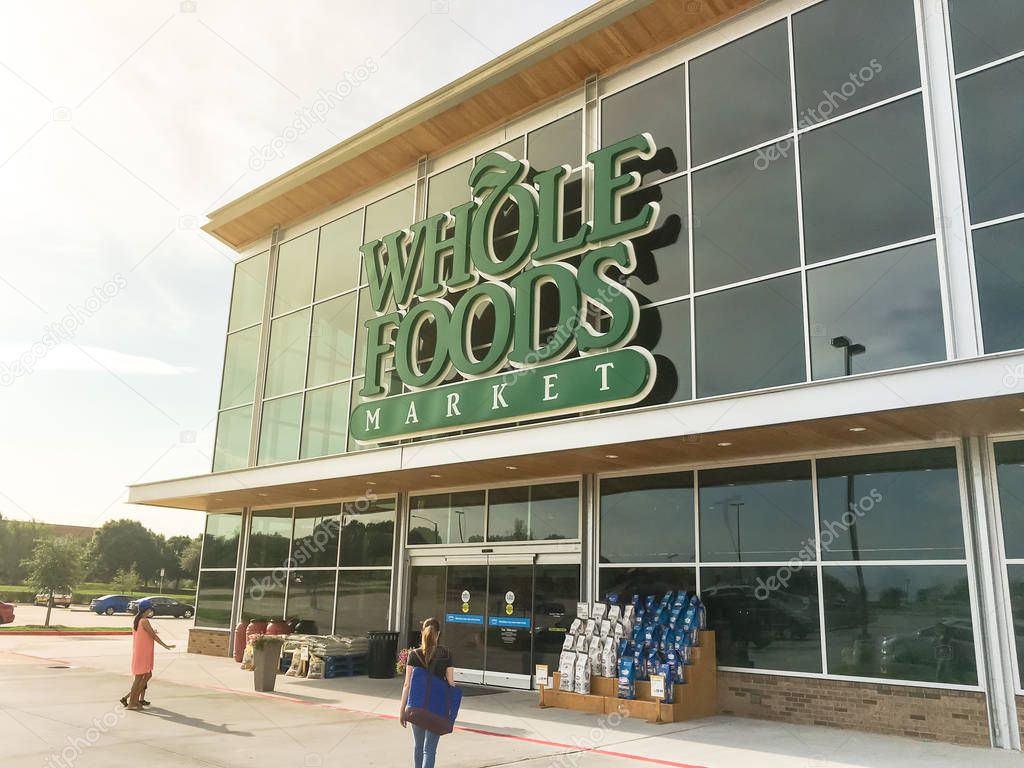 IRVING, TX, US-AUG 19, 2018:Facade entrance of Whole Foods Market store on sunny morning. Eco-minded supermarket chain featuring food without artificial preservatives, colors, flavors, sweeteners