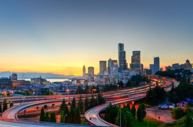 Güzel şehir Seattle gökdelenler ve turuncu gün batımında I-90 Kavşağı I-5 çevre yolu. Trafik ışığı uzun pozlama görünümünü saatinde rotaları. Jose s. ali rıza köprü görünümünden (12 Köprüsü)