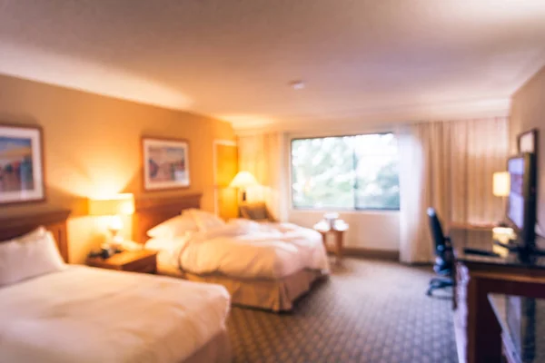 Vintage tone motion blurred typical double room with windows, flat-screen TVs in American hotel