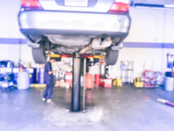 Motion Blurred Abstract Mechanic Changing Oil Lifted Car Auto Shop — Stock Photo, Image