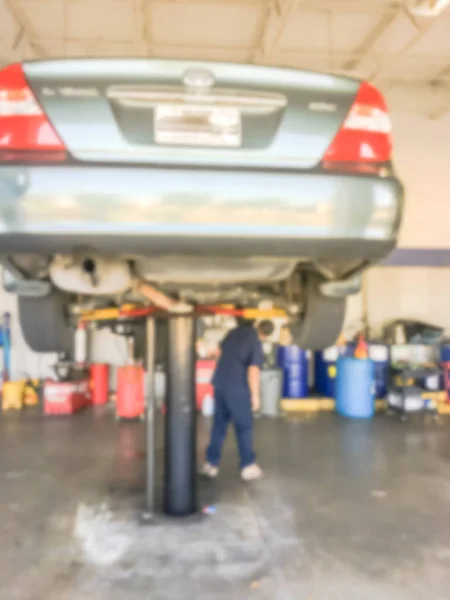Motion Blurred Abstract Mechanic Changing Oil Lifted Car Auto Shop — Stock Photo, Image
