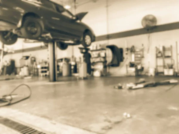 老式色调模糊抽象提升汽车在美国德克萨斯州的汽车商店 弥散现代石油换油服务站的背景内部 车库概念工作技术员 — 图库照片