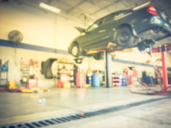 Motion Blurred Abstract Mechanic Changing Oil Lifted Car Auto Shop — Stock Photo, Image