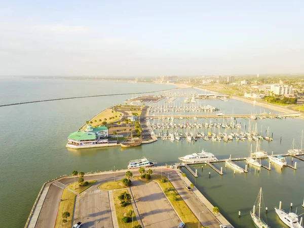 Aerial view Corpus Christi waterfront and marina piers filled row of boat, sailboat and yacht at early morning light. Waterfront area of Texas city on Gulf of Mexico, Southern vacation gateway