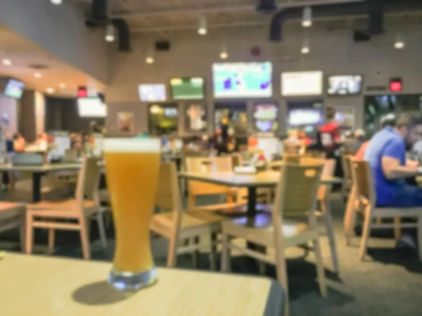 Blurred abstract fresh wheat beer in weizen glasses at  casual dining restaurant and sports bar in America