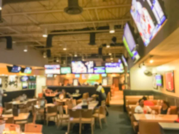 Bulanık soyut barlar restoranlar ABD spor. Ufuk kişi spor izle, bira içmek ve Amerikan mutfağı yemek