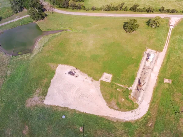 Havadan görünümü çalışma etmek ham petrol ve petrol sondaj, Su emülsiyon pompalıyor kırsal La Grange, Texas, bize site. Enerji ve Sanayi arka plan için eski etmek ve petrol tankları.