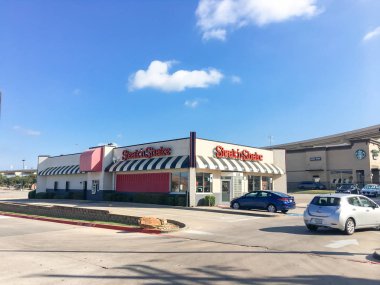 LEWISVILLE, TX, USA-SEP 2, 2018:Facade entrance of Steak n Shake near stack highway. American casual restaurant chain with sit-down, drive-thru and front-window service. Based in Indianapolis, Indiana clipart