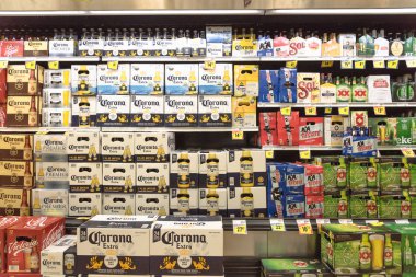 FORT WORTH, TX, USA-SEP 3, 2017:Wide selection of domestic and imported beer at Fiesta Latino-American supermarket chain. Various bottles and cans of Mexican and international beers Corona, Heineken clipart