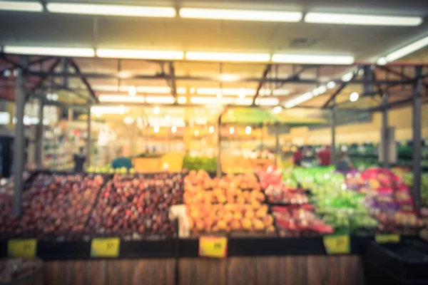 Vintage tone blurred people shopping at local Latino-American supermarket chain in US. Customer buying fresh fruits, vegetables. Organic locally grown produces display. Healthy food in grocery store
