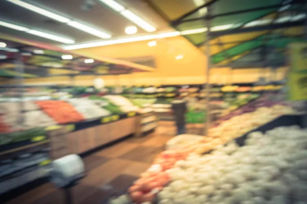 Vintage tone blurred people shopping at local Latino-American supermarket chain in US. Customer buying fresh fruits, vegetables. Organic locally grown produces display. Healthy food in grocery store