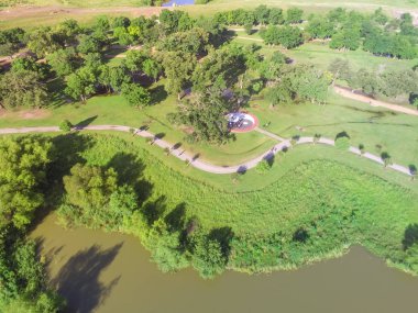 Hava kentsel lakeside yeşil park banliyö Houston. Yol, S-kavisli ağaçlar, yeşil çim, trail koşu, çalıştırma, Ying Yang ortada açık, büyük Tai Chi çemberi egzersiz için göl kıyısı tarafından