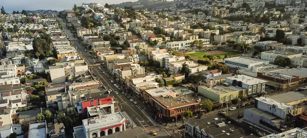 Panorama aerial view Eureka Valley neighborhood with rolling hills cityscape, typical Victorian houses. Castro District is synonymous with gay culture, tightly packed residential homes summer foggy