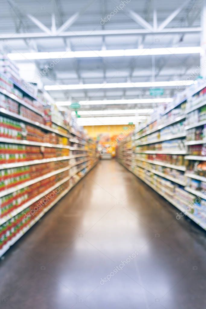 Blurred selection of pasta, ketchup, condiment, tomato sauce and canned vegetable on shelves in store at Humble, Texas, US. Aisle, row variety products, defocused background, bokeh light supermarket.