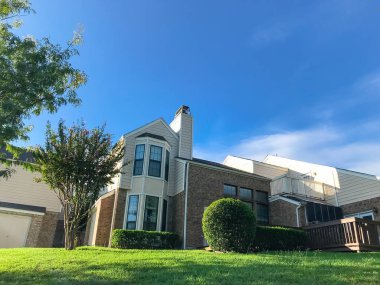 Dallas-Fort Worth varoş mahallesinde karmaşık townhouse, düşük açılı görünümü yeşil çimenli çim arka. Bakımlı ve kesilmiş manzara