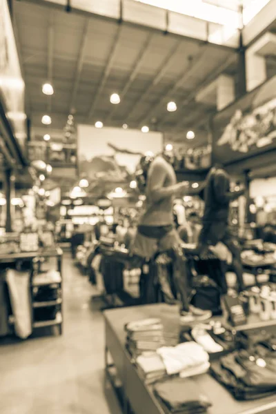 Vintage tone blurred image interior of sports and fitness clothing store in America. Sport shop with famous sports fashion brand worldwide of athletic shoes, gear, apparel. Healthy lifestyle concept