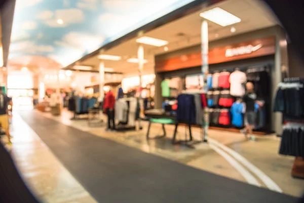 Blurred image interior of sports and fitness clothing store in America. Sport shop with famous sports fashion brand worldwide of athletic shoes, gear and apparel. Healthy lifestyle concept background.