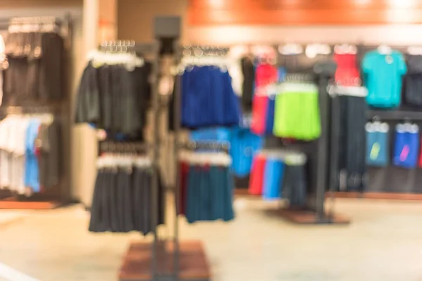 Blurred image interior of sports and fitness clothing store in America. Sport shop with famous sports fashion brand worldwide of athletic shoes, gear and apparel. Healthy lifestyle concept background.