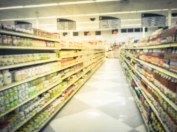 Vintage tone blurred variety of sauces, pickled vegetable, vinegar, cooking wine on shelves at Asian grocery store in Dallas, Texas, America. Defocused row, aisles of traditional Vietnamese dressing