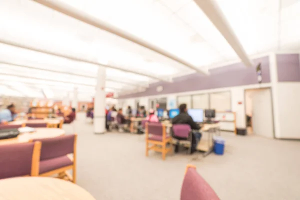 Blurred image of computer station at the public library in Humble, Texas, US. Library interior with unidentified people are searching and reading information. Continued education abstract background. — Stock Image Blurred Image Computer Station Public Library Humble Texas Library Interior Royalty Free Stock Images
