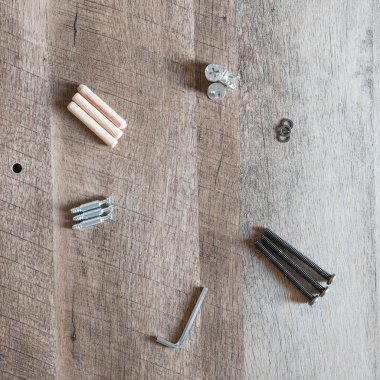 Üstten görünüm düzenleme grubu için araya hazır ahşap mobilya montaj kopya alanı ile vintage ashwood gemide parçalar (dübel, cıvata, çamaşır makinesi, allen anahtarı, vida). DIY konsepti için aletleri.