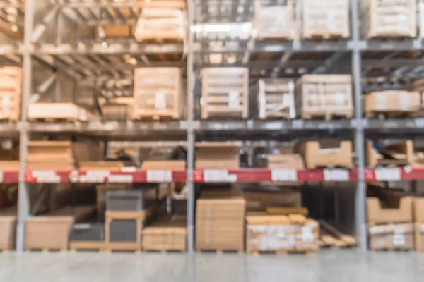 Blurred full-frame image aisles and bins at furniture warehouse in America. Defocused abstract industrial storehouse interior full of boxes, shelves, racks from floor to ceiling