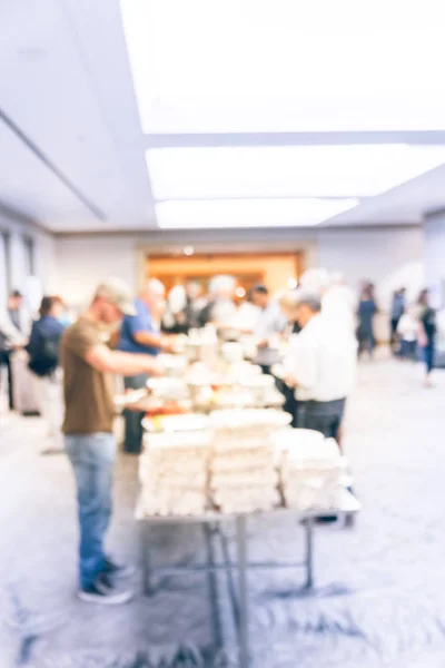 Vintage tone blurred diverse group of people at continental breakfast of workshop event in suburban Dallas, Texas, USA. Defocused catering food self-service meal table at hotel hall banquet