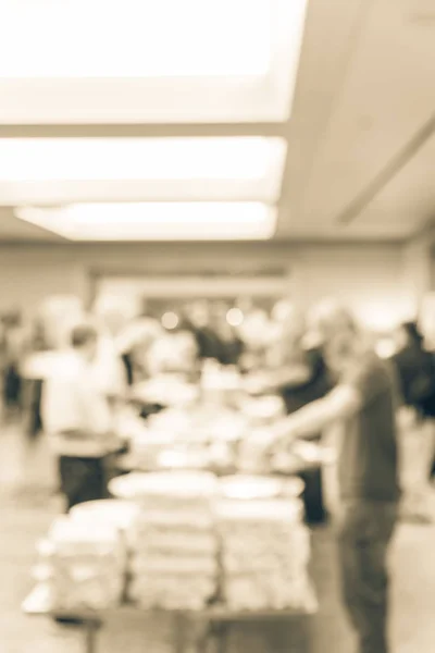 Vintage tone blurred diverse group of people at continental breakfast of workshop event in suburban Dallas, Texas, USA. Defocused catering food self-service meal table at hotel hall banquet