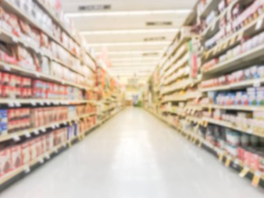 Abstract blurred low angle view bake time, spices, cake mixes, cooking oil, gelatin, cooking gadgets, food storage aisle at grocery store in Irving, Texas, US. Supermarket shelves variety of products clipart