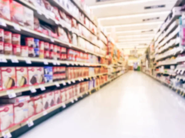 Abstract blurred low angle view bake time, spices, cake mixes, cooking oil, gelatin, cooking gadgets, food storage aisle at grocery store in Irving, Texas, US. Supermarket shelves variety of products