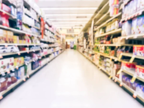 Abstract blurred low angle view bake time, spices, cake mixes, cooking oil, gelatin, cooking gadgets, food storage aisle at grocery store in Irving, Texas, US. Supermarket shelves variety of products