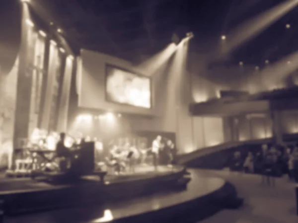 Vintage tone blurry abstract worship band and the choir at Bible Church in Texas, USA. Dark background, smoke, concert spotlights for Christian concept. Worship lyric projection