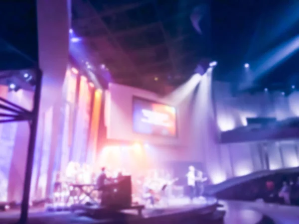 Blurry abstract worship band and the choir at Bible Church in Texas, USA. Dark background, smoke, concert spotlights for Christian concept. Worship lyric projection