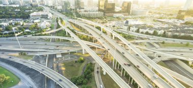 Panorama Hava eyaletler arası I-610 otoyol büyük kavşak ve Houston midtown silüetini arka plan. Değişim, yükseltilmiş yol Kavşağı Üstgeçit viyadük yığını. Her gece derecesi görünümü metropol