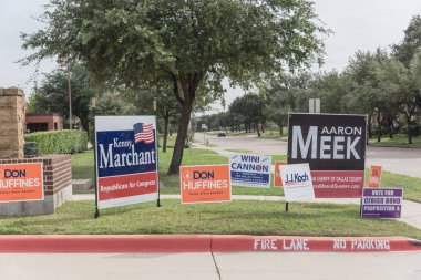 IRVING, TX, USA-OCT 22, 2018:Row of yard sign at residential street for primary election day in Dallas county, Texas, USA. Signs greeting early voters, political party posters for the midterm election clipart