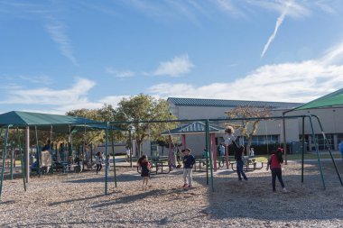 Dallas, Tx, ABD-Kasım 2, 2018: renkli sonbahar yaprakları ile banliyö Dallas kamu Park'ta güzel bahçesi. Etrafta çocuklar keyif, slayt, salıncak, Tüp, bankta oturan anne atlama