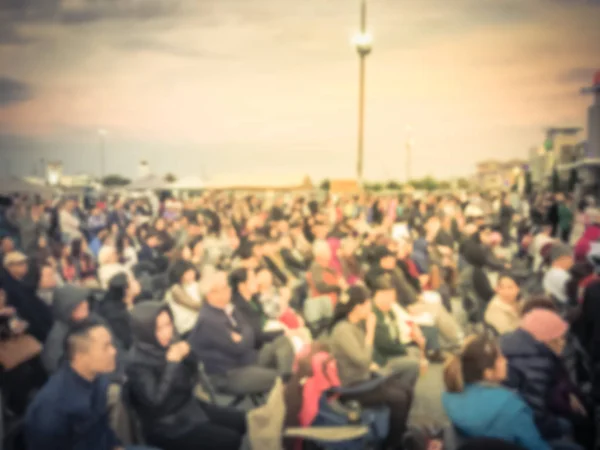 Vintage tone large group of Asian audience enjoy themselves at outdoor music festival at sunset