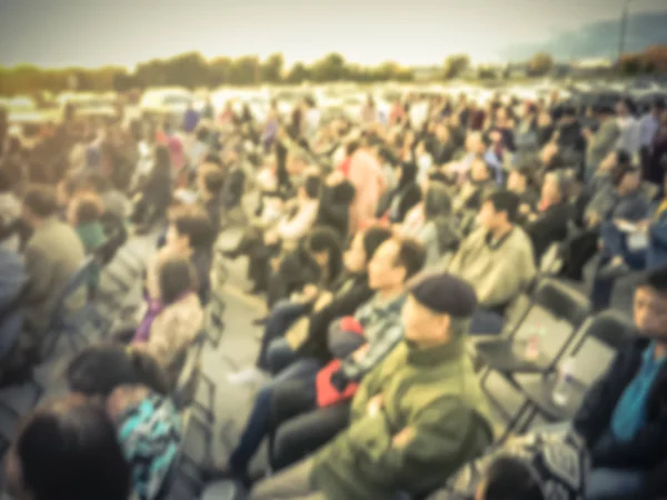 Vintage tone large group of Asian audience enjoy themselves at outdoor music festival at sunset