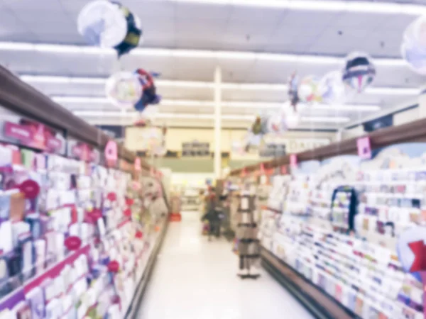 Vintage tone blurred abstract greeting cards and balloons display at grocery store in Texas, America.